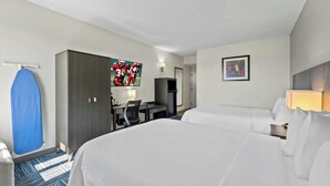A hotel room with two beds, a desk with a chair, a television, and a painting on the wall. - Allentown Park Hotel by The Red Collection (Allentown)