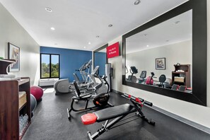 A gym with exercise equipment, a water station, and a sign indicating free Wi-Fi availability. - Allentown Park Hotel by The Red Collection (Allentown)