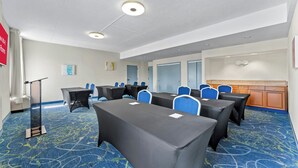 A conference room with tables, chairs, a podium, and a carpeted floor. - Allentown Park Hotel by The Red Collection (Allentown)