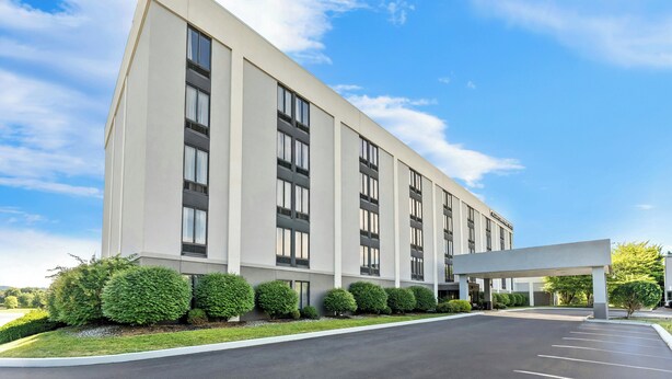 A modern building with a flat roof, large windows, and a covered entrance area. - Allentown Park Hotel by The Red Collection (Allentown)
