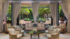 A spacious lounge area with a sofa, armchairs, and a coffee table. - The Windsor Court (New Orleans)