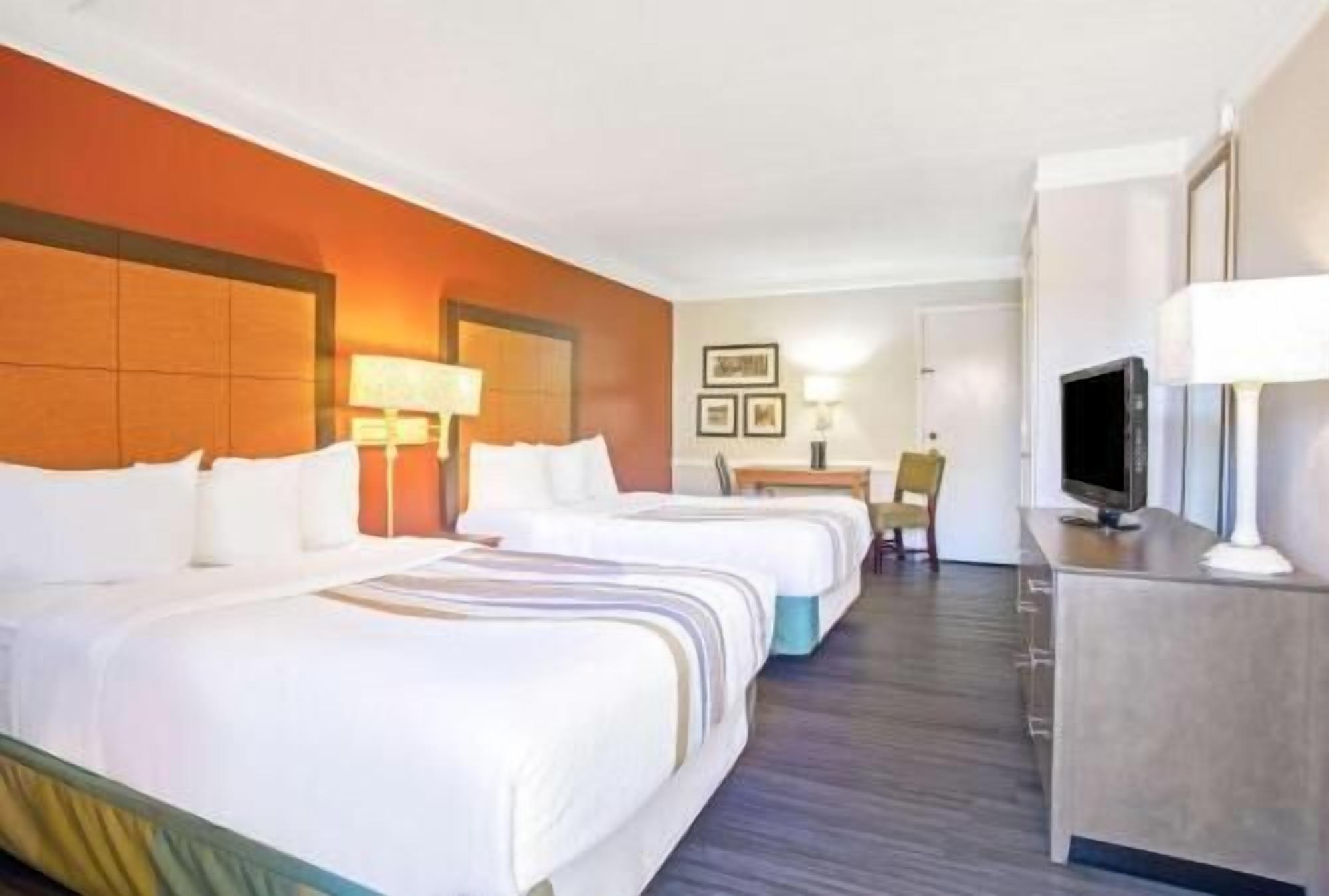 Premium bedding, pillow-top beds, desk, laptop workspace