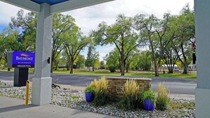 A Baymont by Wyndham indoor pool entrance with a stone wall and potted plants. - Baymont | Monte Vista (Monte Vista)