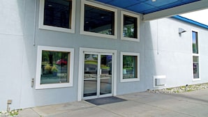 A modern building with large windows and a blue ceiling.
