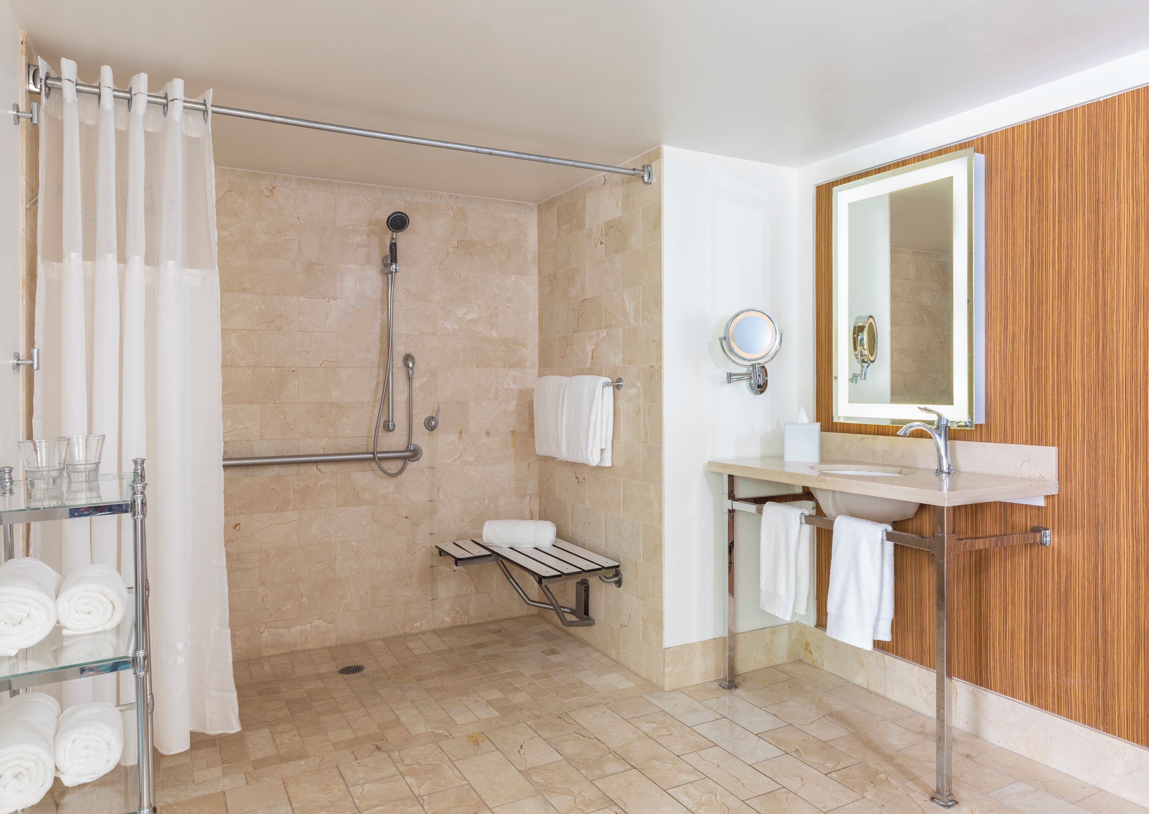 A modern bathroom with a shower, a sink, and a mirror.