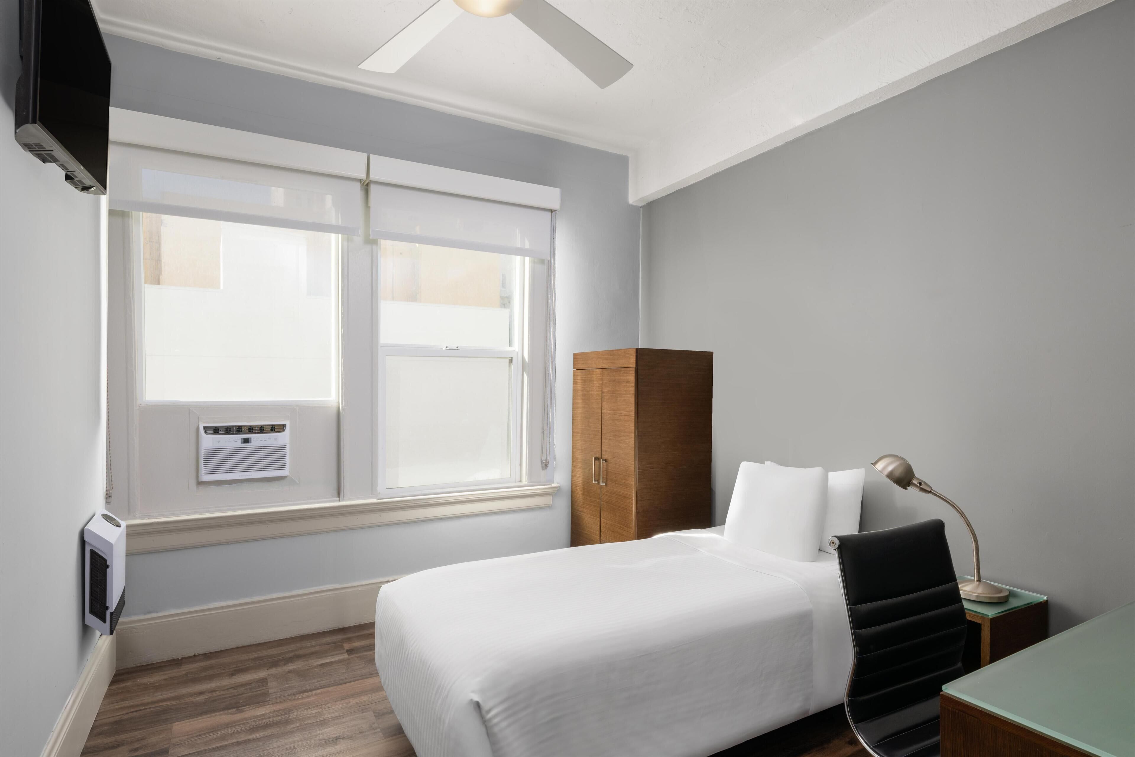 Premium bedding, desk, laptop workspace, blackout curtains