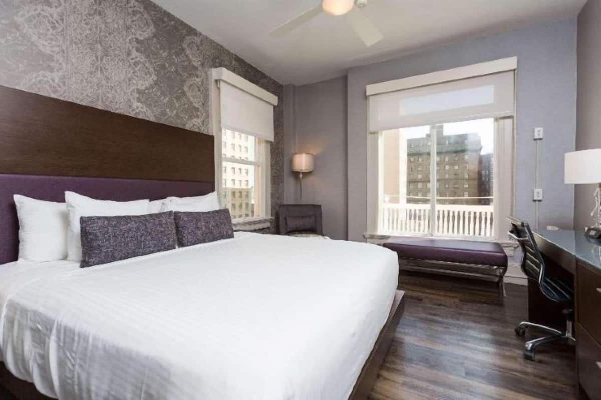 Premium bedding, desk, laptop workspace, blackout drapes