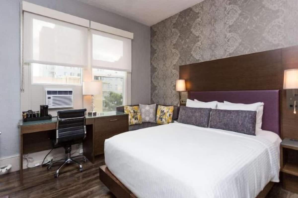 Premium bedding, desk, laptop workspace, blackout drapes