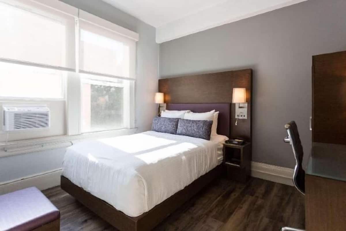 Premium bedding, desk, laptop workspace, blackout drapes