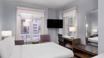 Premium bedding, desk, laptop workspace, blackout drapes