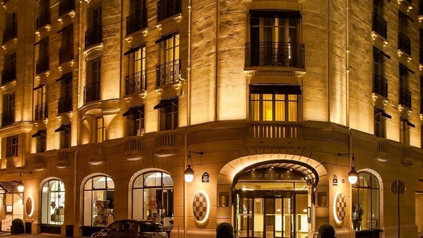 A multi-story hotel with a classic architectural design, featuring arched windows and a grand entrance. - Sofitel Paris Arc de Triomphe (Paris)