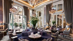 A luxurious lobby with a central seating area, large windows, and ornate chandeliers. - Hôtel de Crillon A Rosewood Hotel (Paris)