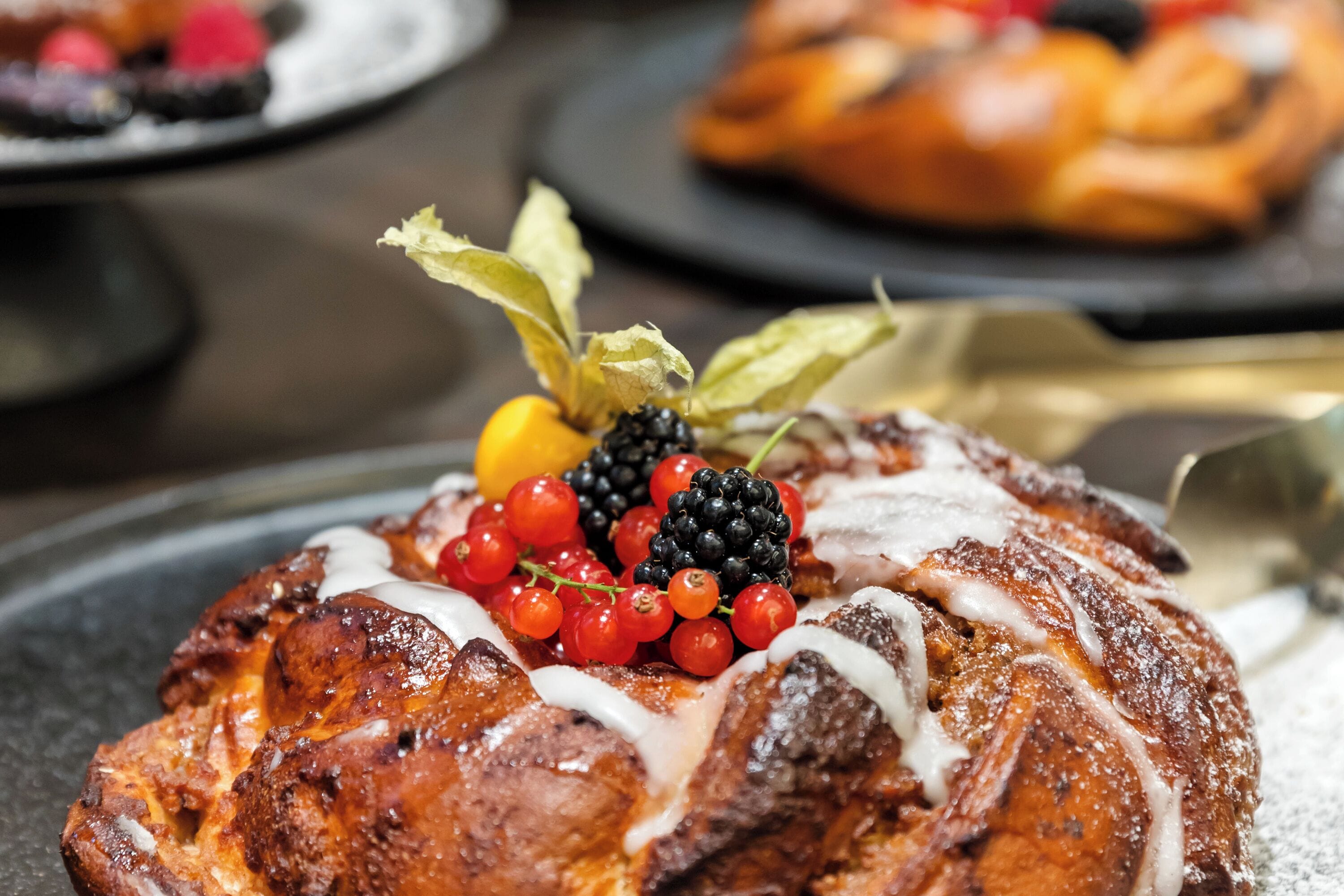A dessert with berries and cream on a plate.