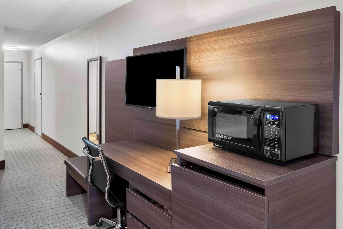 hypo-allergenic bedding, desk, laptop workspace, blackout curtains