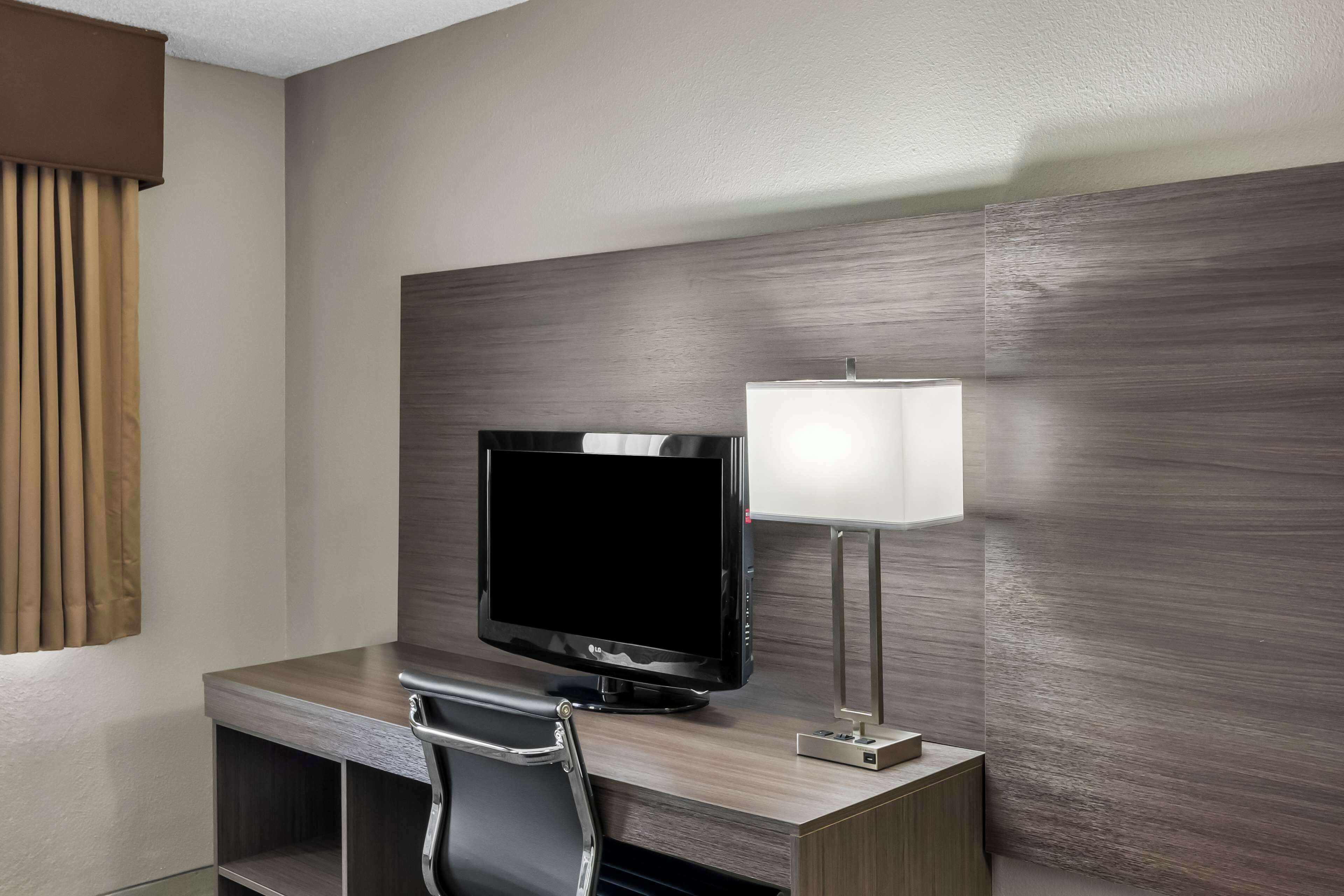 hypo-allergenic bedding, desk, laptop workspace, blackout curtains