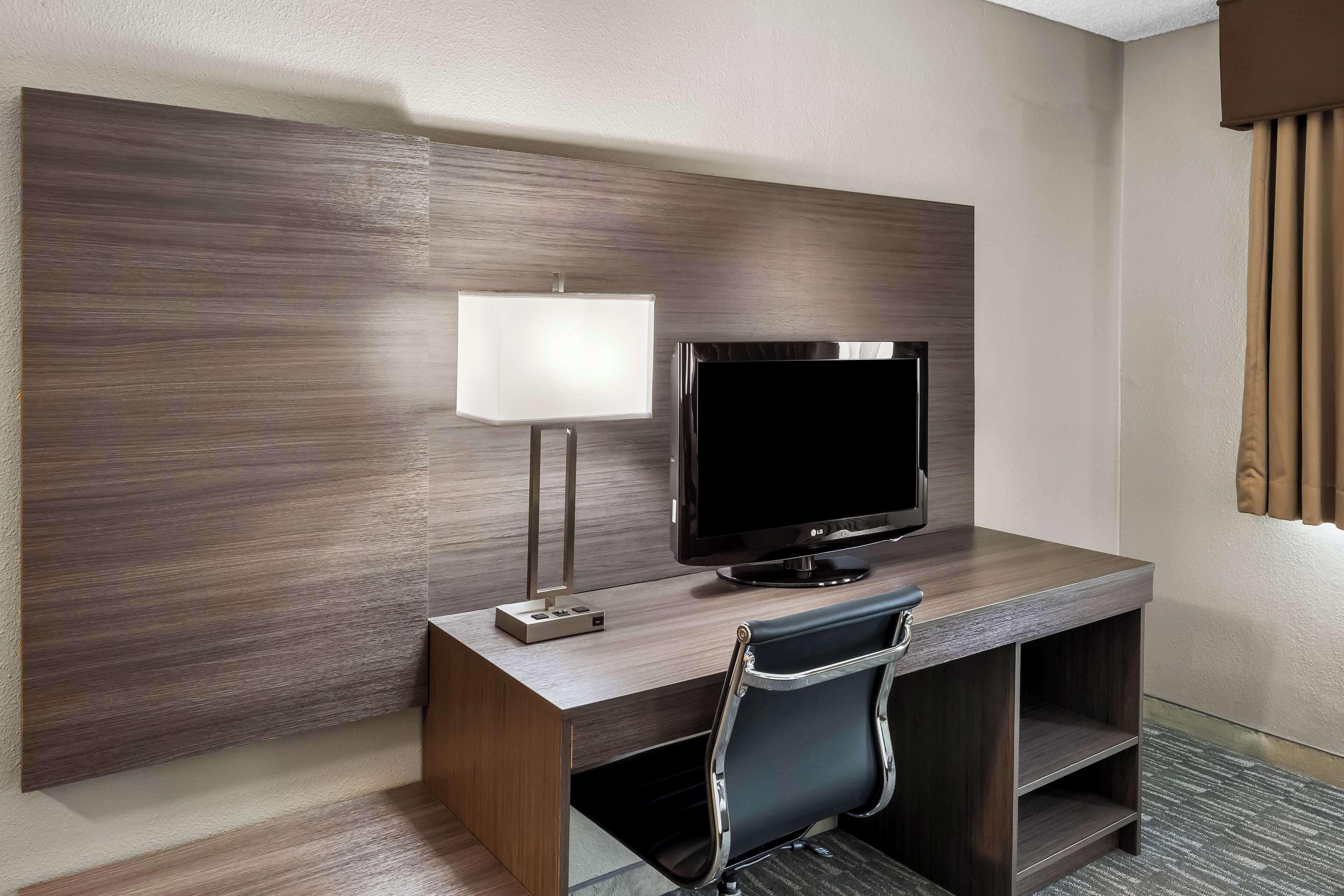 hypo-allergenic bedding, desk, laptop workspace, blackout curtains