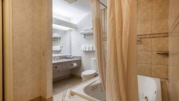 A bathroom with a bathtub, toilet, and sink.