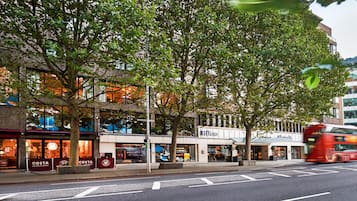 A street view with a Costa Coffee and a Hilton hotel.