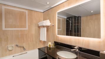 A modern bathroom with a bathtub, a sink, a mirror, and a shower.
