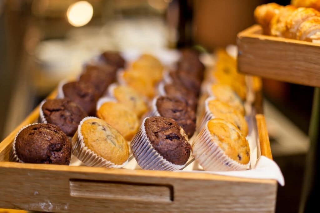 A wooden tray with various muffins.