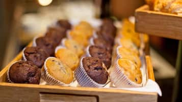 A wooden tray with various muffins.
