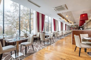 Enjoy dining in this spacious restaurant with a high ceiling and city views.