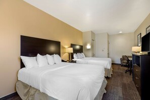 A hotel room with two beds, a desk, a chair, a TV, and a lamp. - Best Western Pioneer (Lusk)