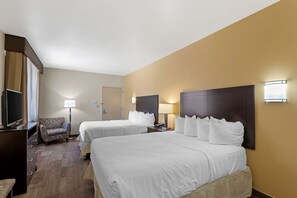 A hotel room with two beds, a TV, a desk, and a chair. - Best Western Pioneer (Lusk)