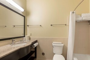 A bathroom with a sink, toilet, and shower area. - Best Western Pioneer (Lusk)