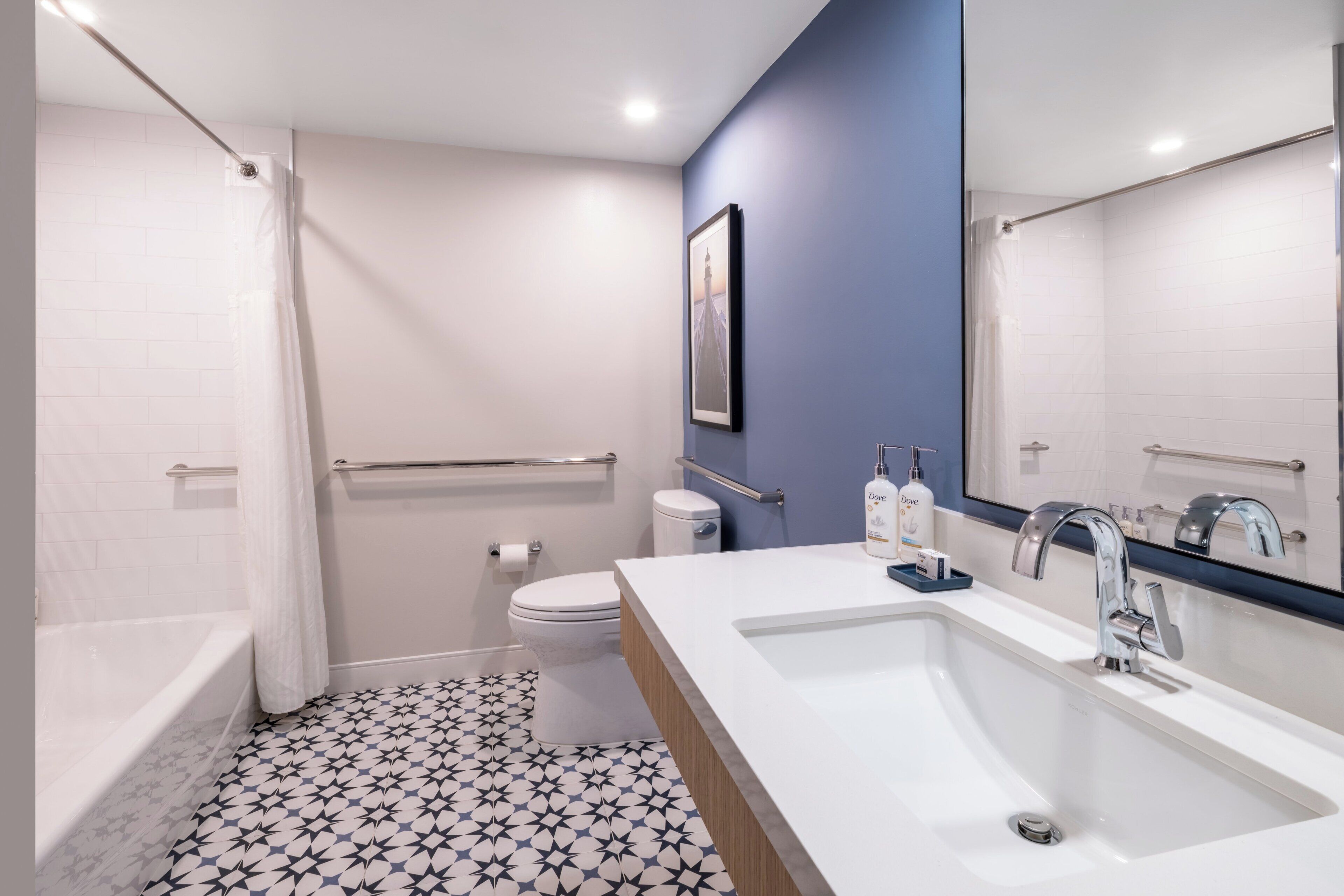 A modern bathroom with a bathtub, toilet, and sink.