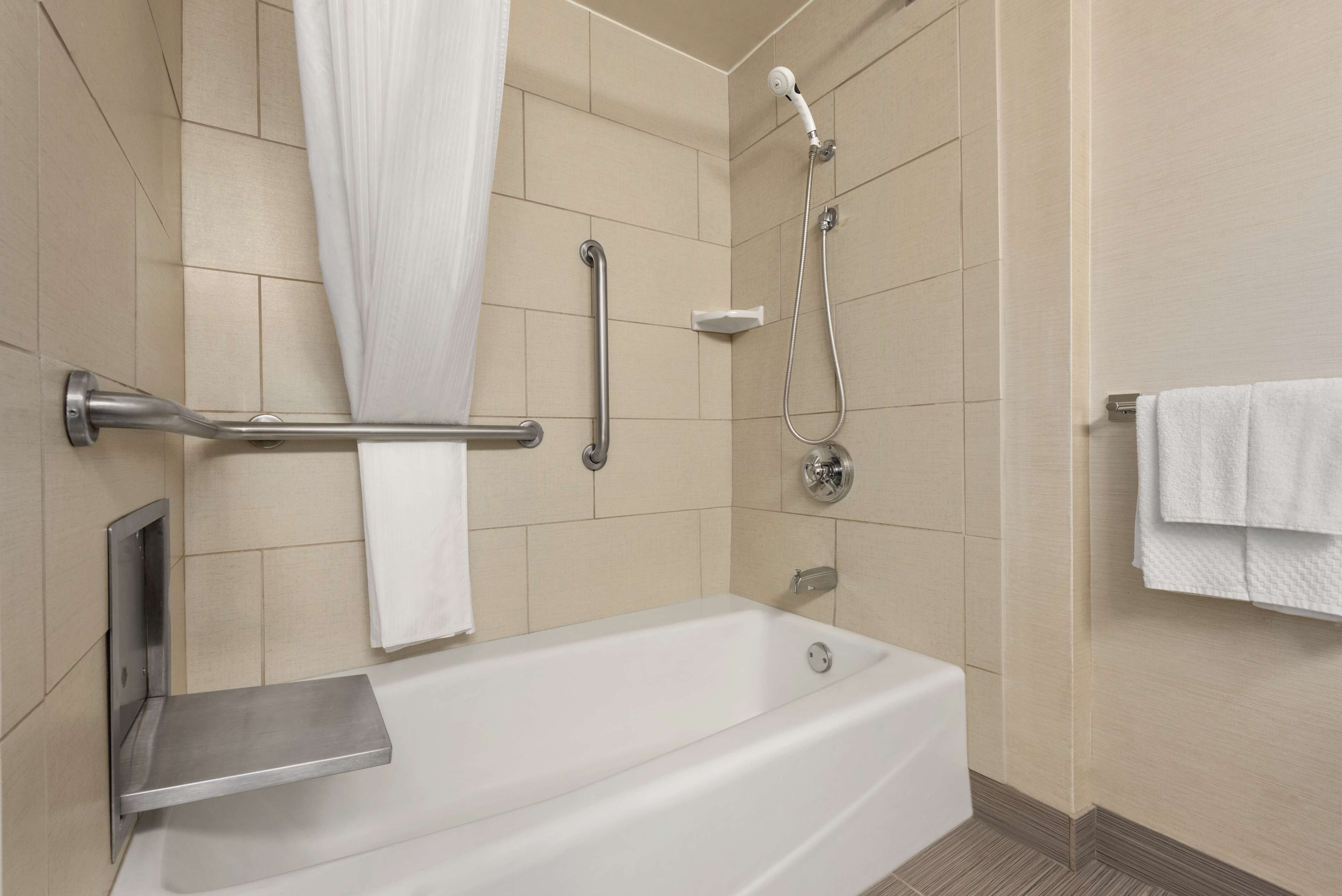 combined shower/bathtub, designer toiletries, hair dryer, towels