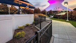 A modern building with a unique, curved roof structure. - The Cheshire (Richmond Heights)