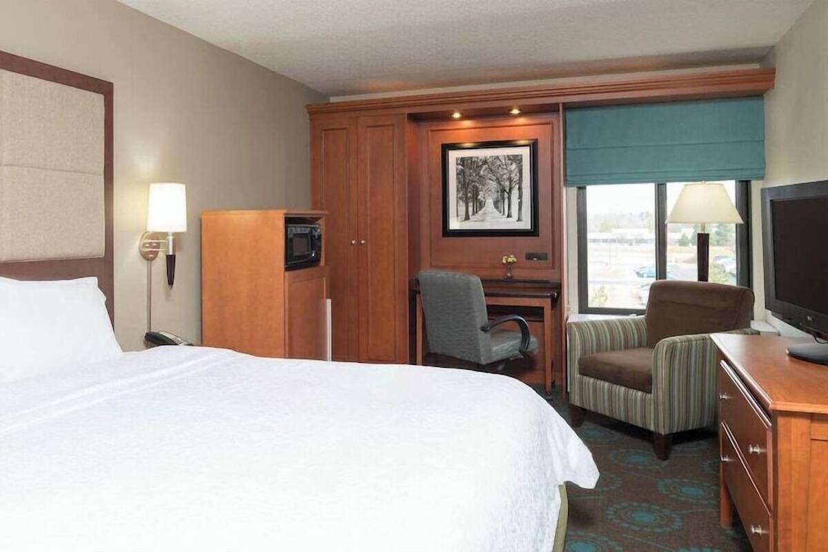 Premium bedding, desk, laptop workspace, blackout drapes