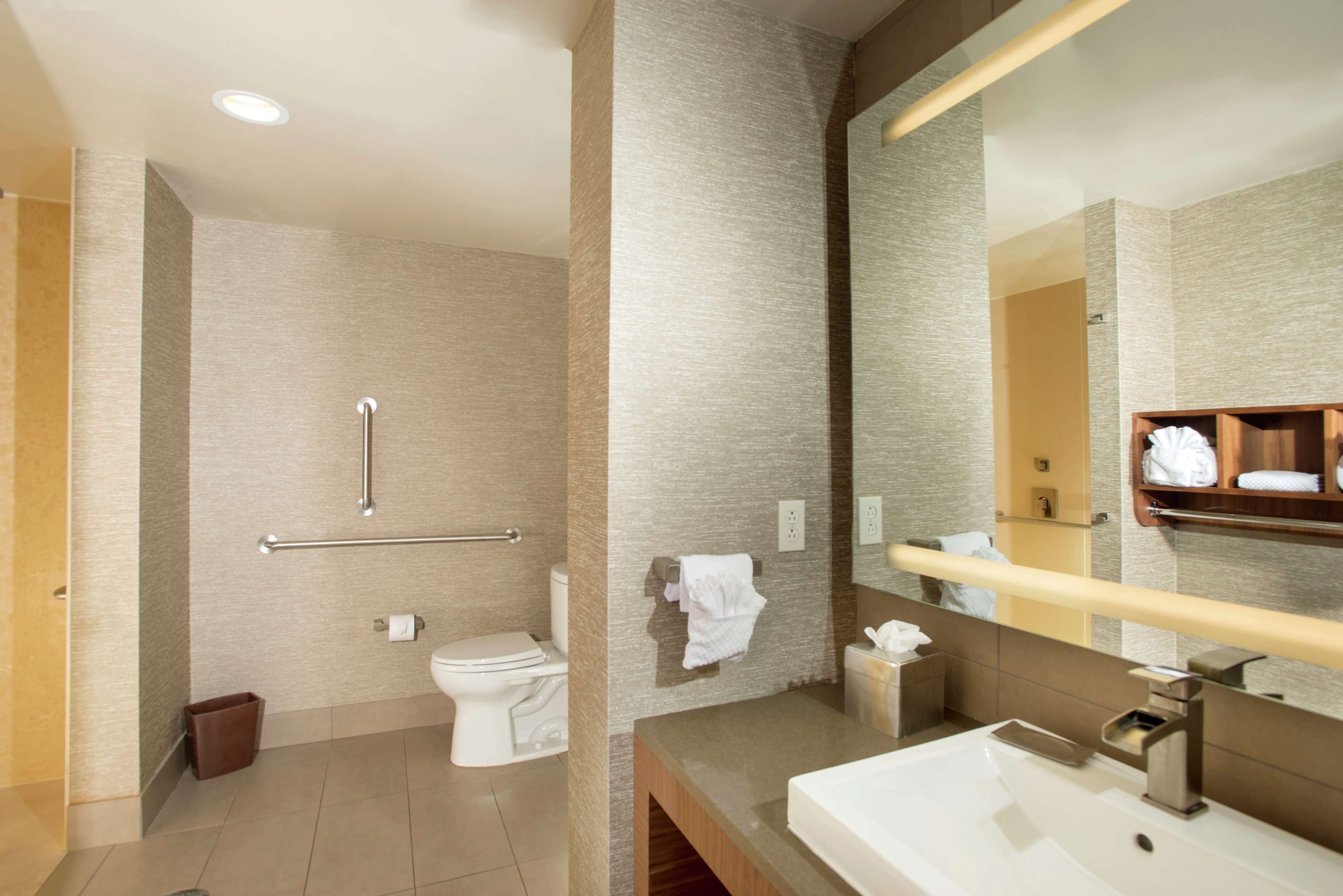 A modern bathroom with a toilet, bidet, and a sink.