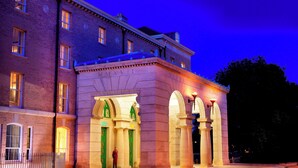 A historic building with arched entrances and a brick facade. - University Arms, Autograph Collection (Cambridge)