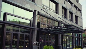 A modern building with large glass windows and a sign reading "Thompson Chicago". - Thompson Chicago, by Hyatt (Chicago)