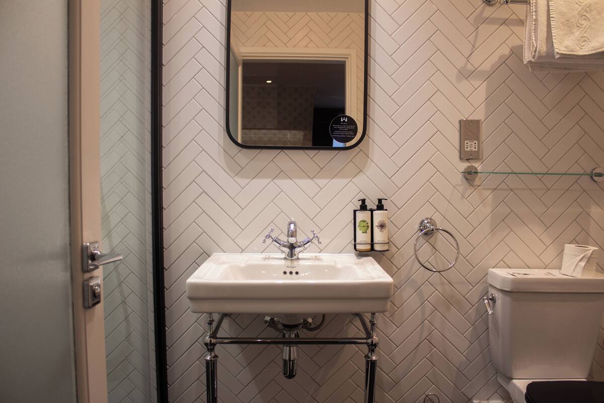 suite | bathroom | shower, hair dryer, towels