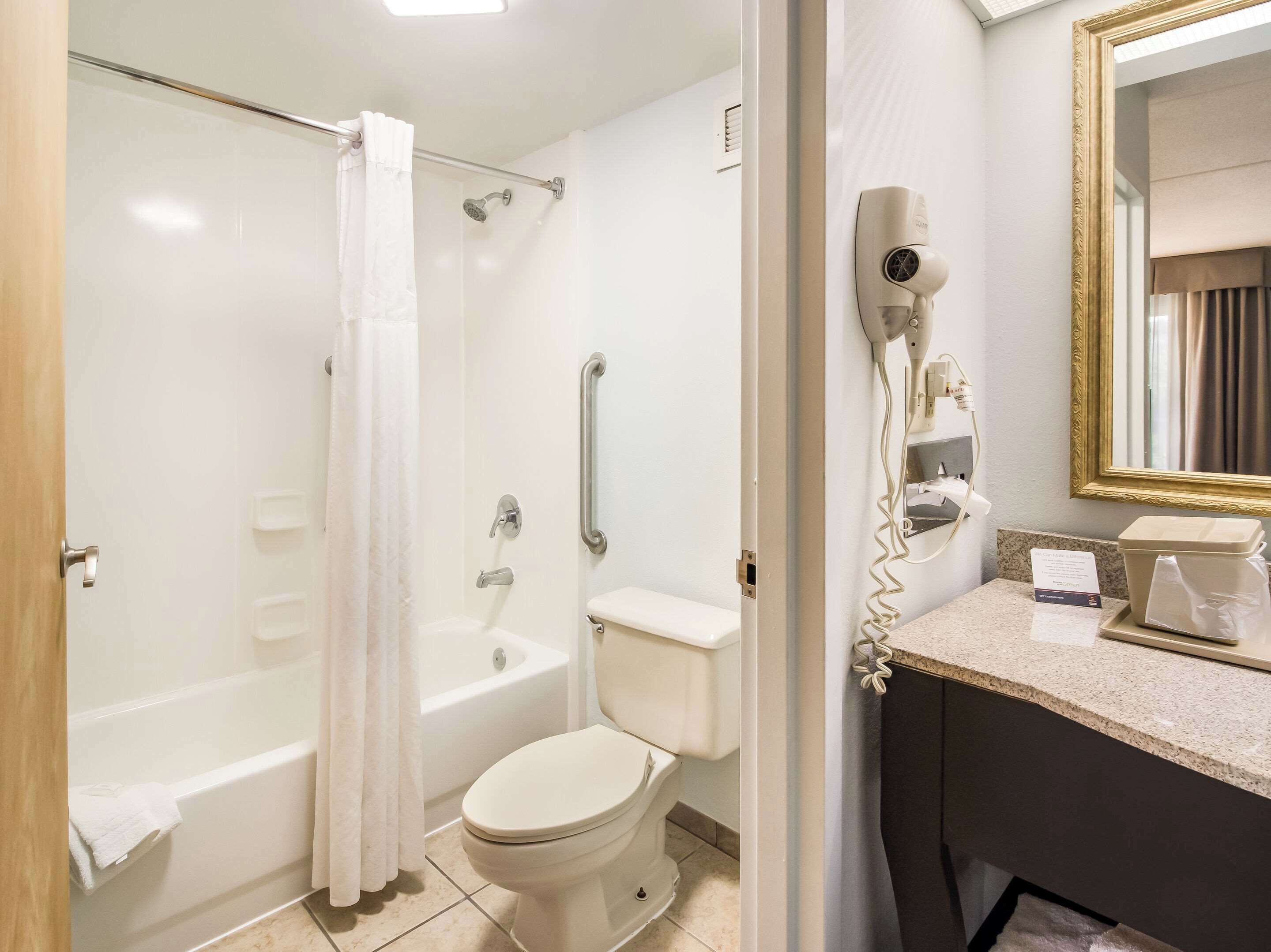 A bathroom with a bathtub, toilet, and shower.