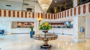 A lobby with a reception desk, a chandelier, and a marble floor. - Danubius Hotel Regents Park (London)