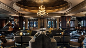 A luxurious lobby with a grand chandelier, a piano, and a modern sectional sofa. - Langham Huntington, Pasadena, Los Angeles (Pasadena)
