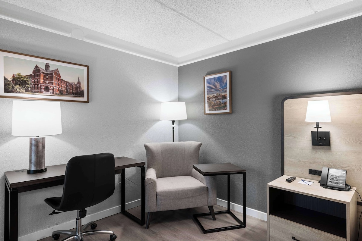 Premium bedding, desk, laptop workspace, blackout drapes
