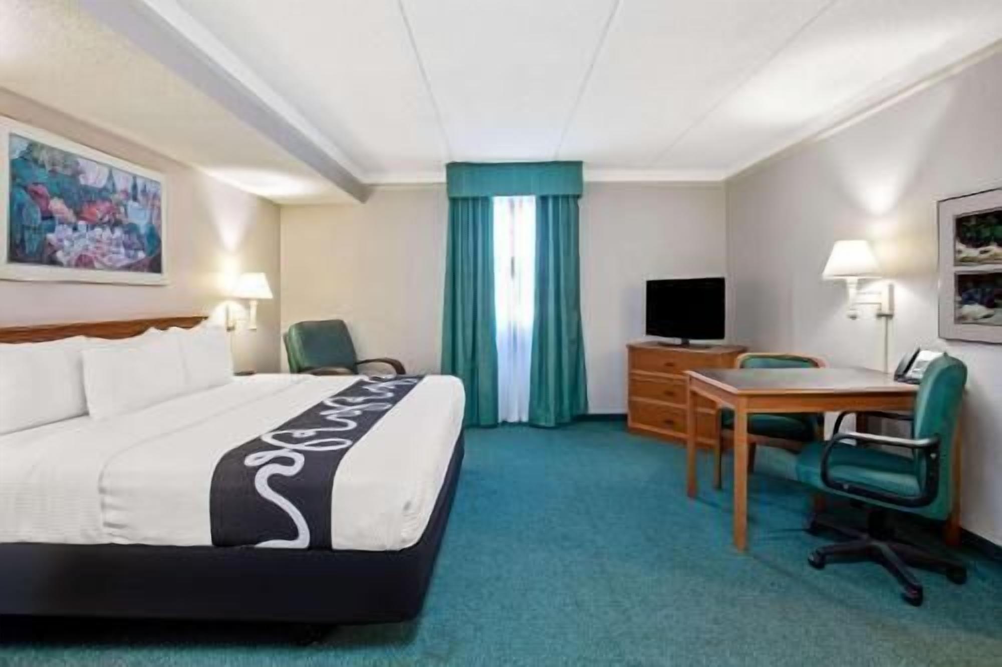 Premium bedding, desk, laptop workspace, blackout curtains