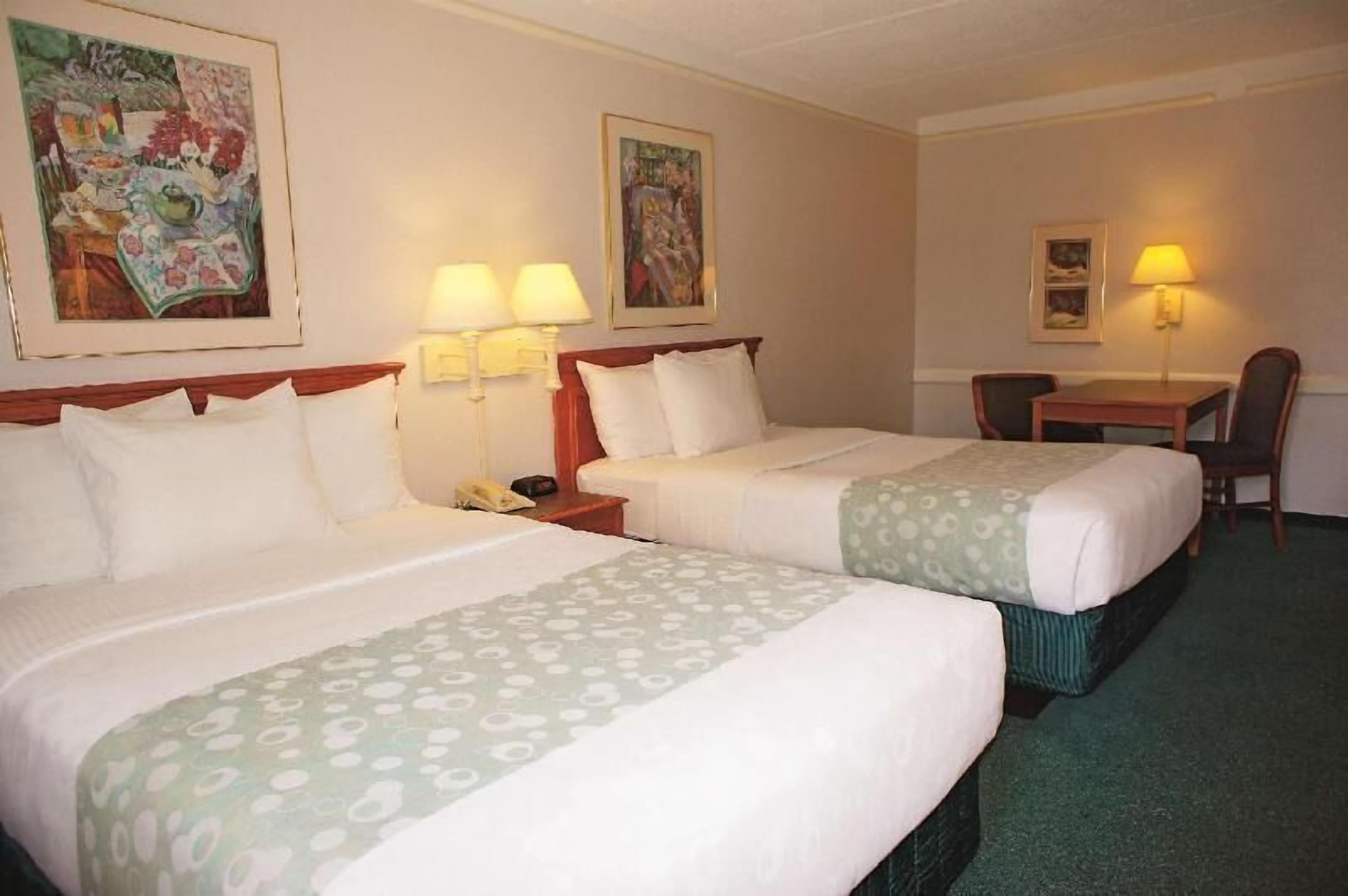 Premium bedding, desk, laptop workspace, blackout drapes