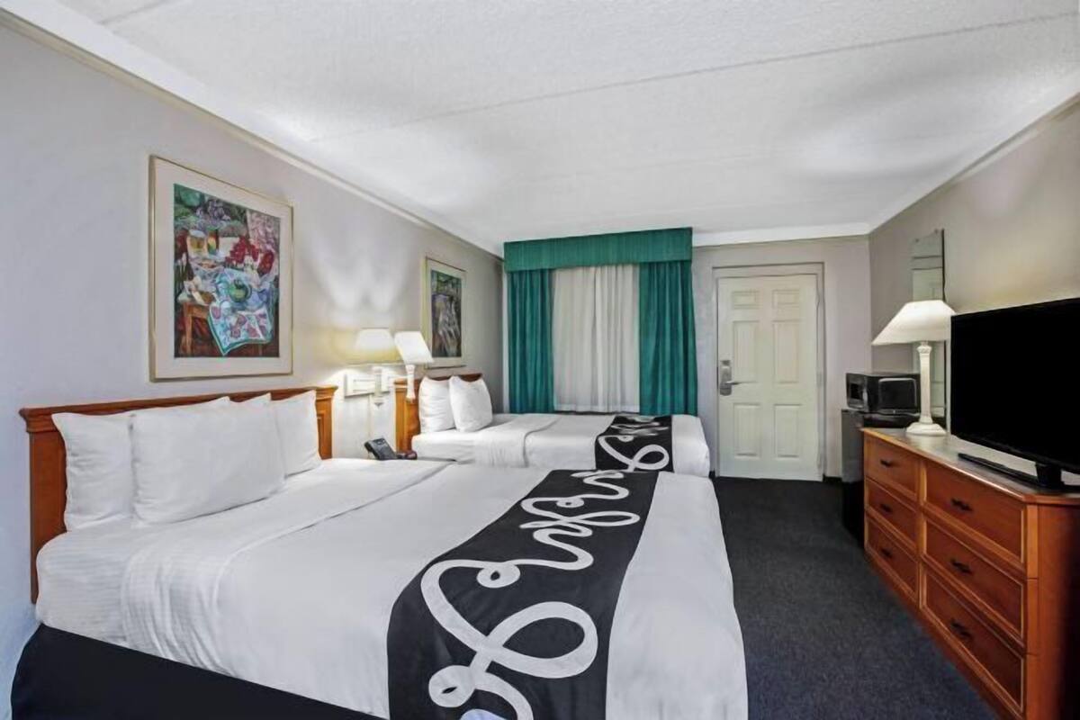 Premium bedding, desk, laptop workspace, blackout curtains