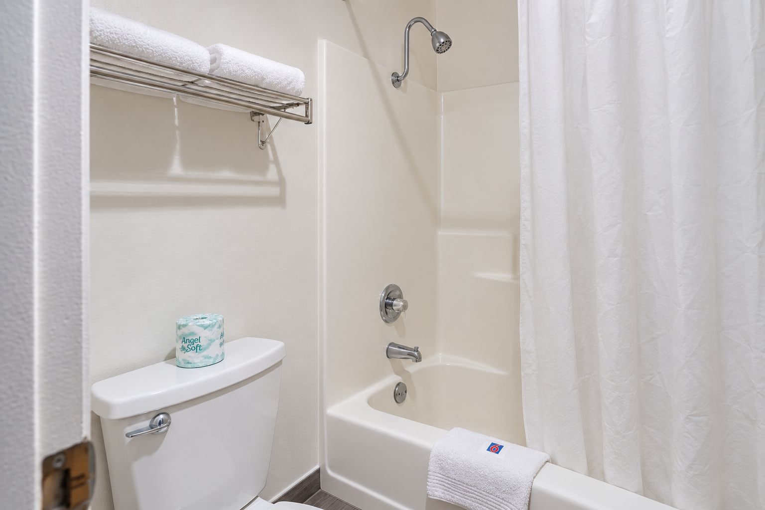 A bathroom with a toilet, a shower, and a bathtub.