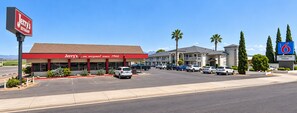 A commercial building with a red facade and a sign for 'Jerry's Restaurant' with a parking lot in front. - Motel 6 Safford, AZ (Safford)