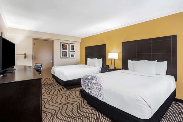 A hotel room with two beds, a desk, a TV, and a door. - La Quinta Inn & Suites by Wyndham Carlsbad - Legoland Area (Carlsbad)