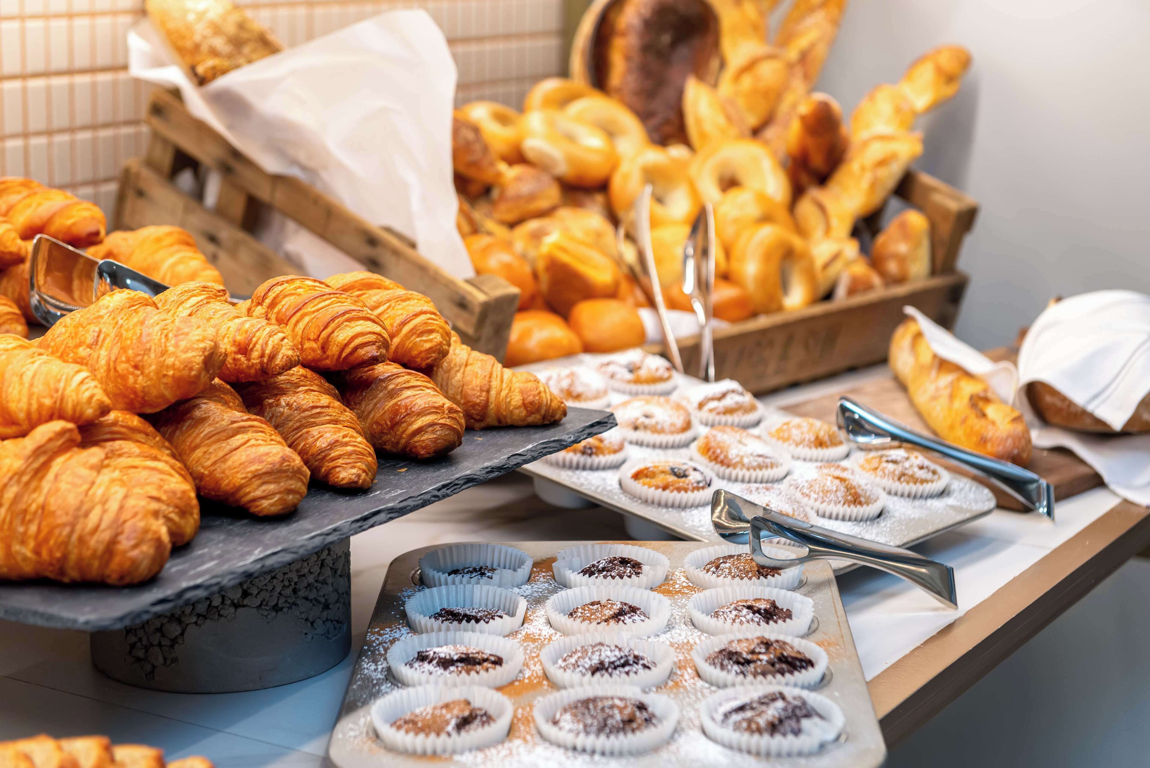 A variety of pastries including croissants and muffins on display.