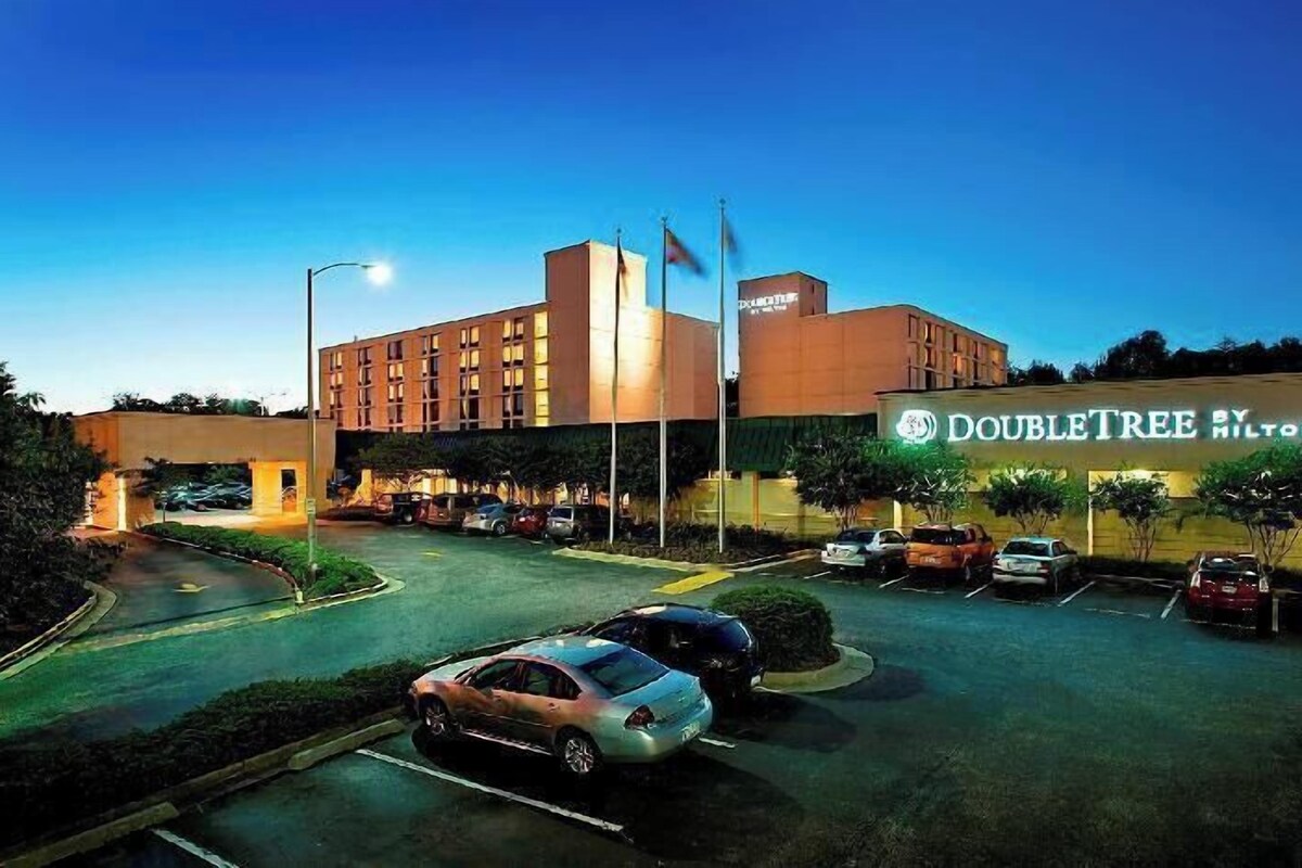 A DoubleTree by Hilton hotel with a parking lot and a building with a sign.