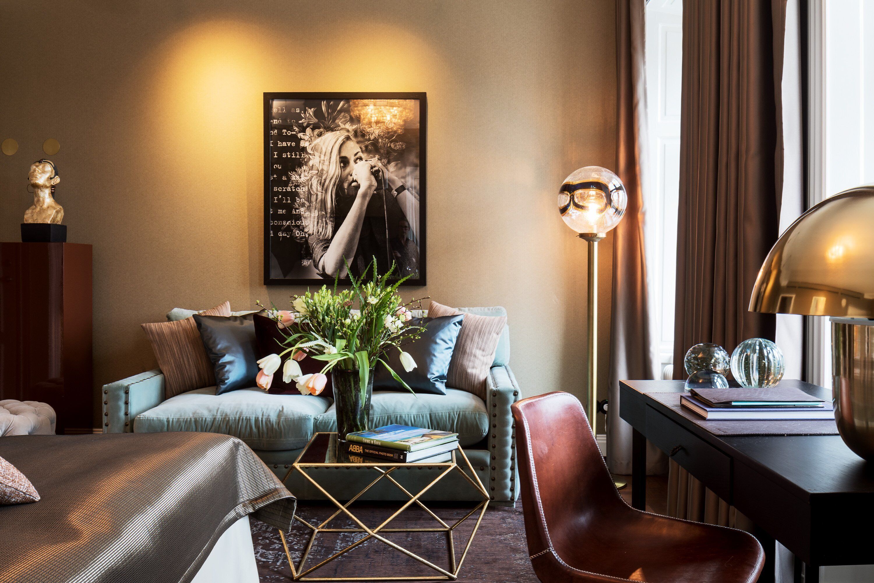 A modern living room with a sofa, coffee table, and a lamp.